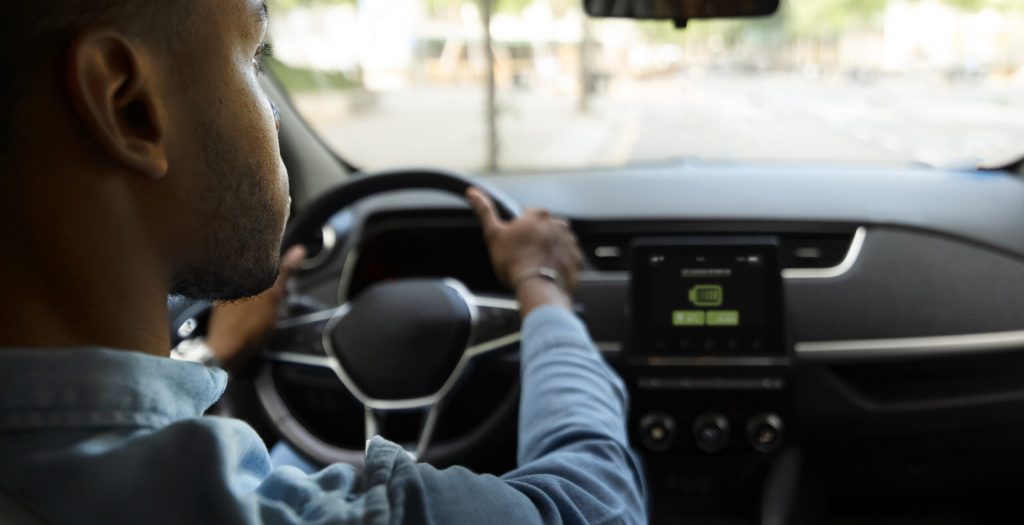 man-driving-electric-car-back-view